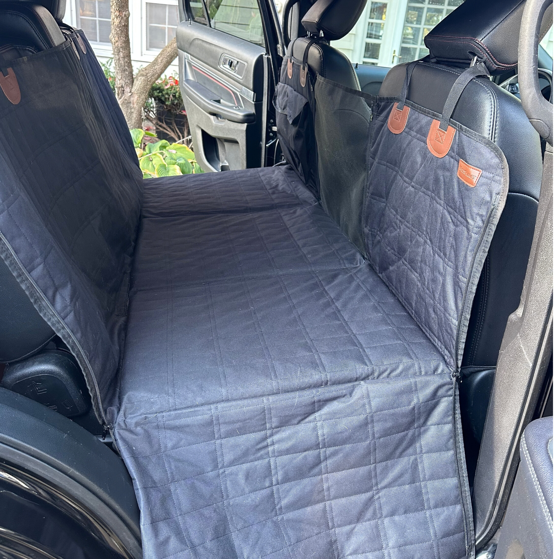 Calming car bed installed across vehicle back seat showing full coverage